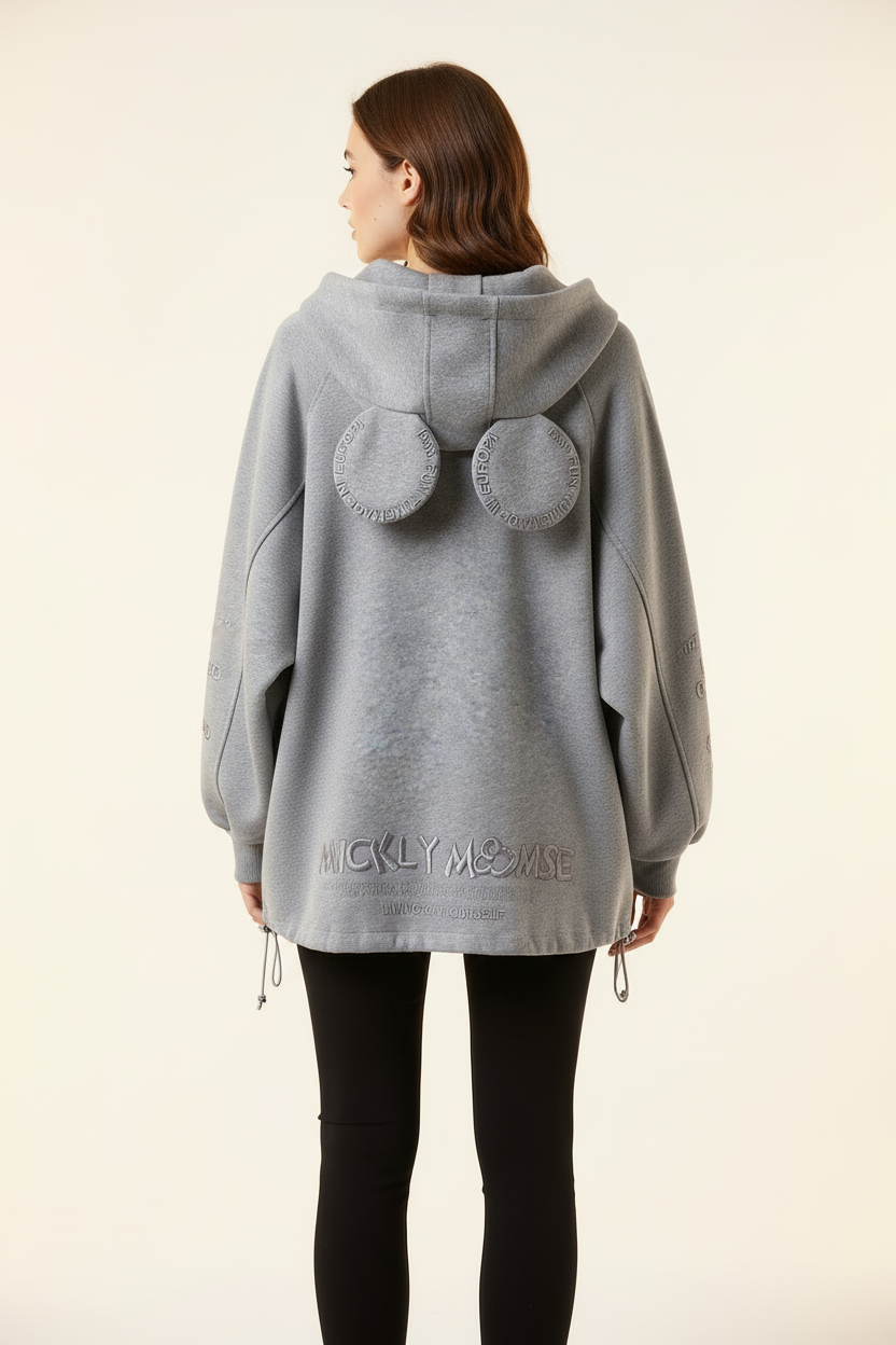 Female model wearing gray hoodie, back view